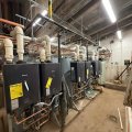 Rinnai tankless water heaters installed in a mechanical room by Squad V Plumbing