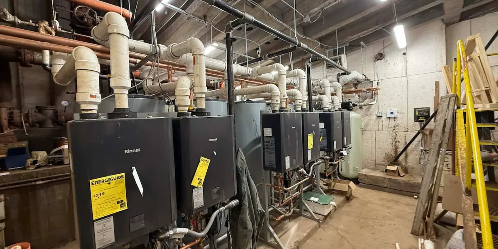 Rinnai tankless water heaters installed in a mechanical room by Squad V Plumbing