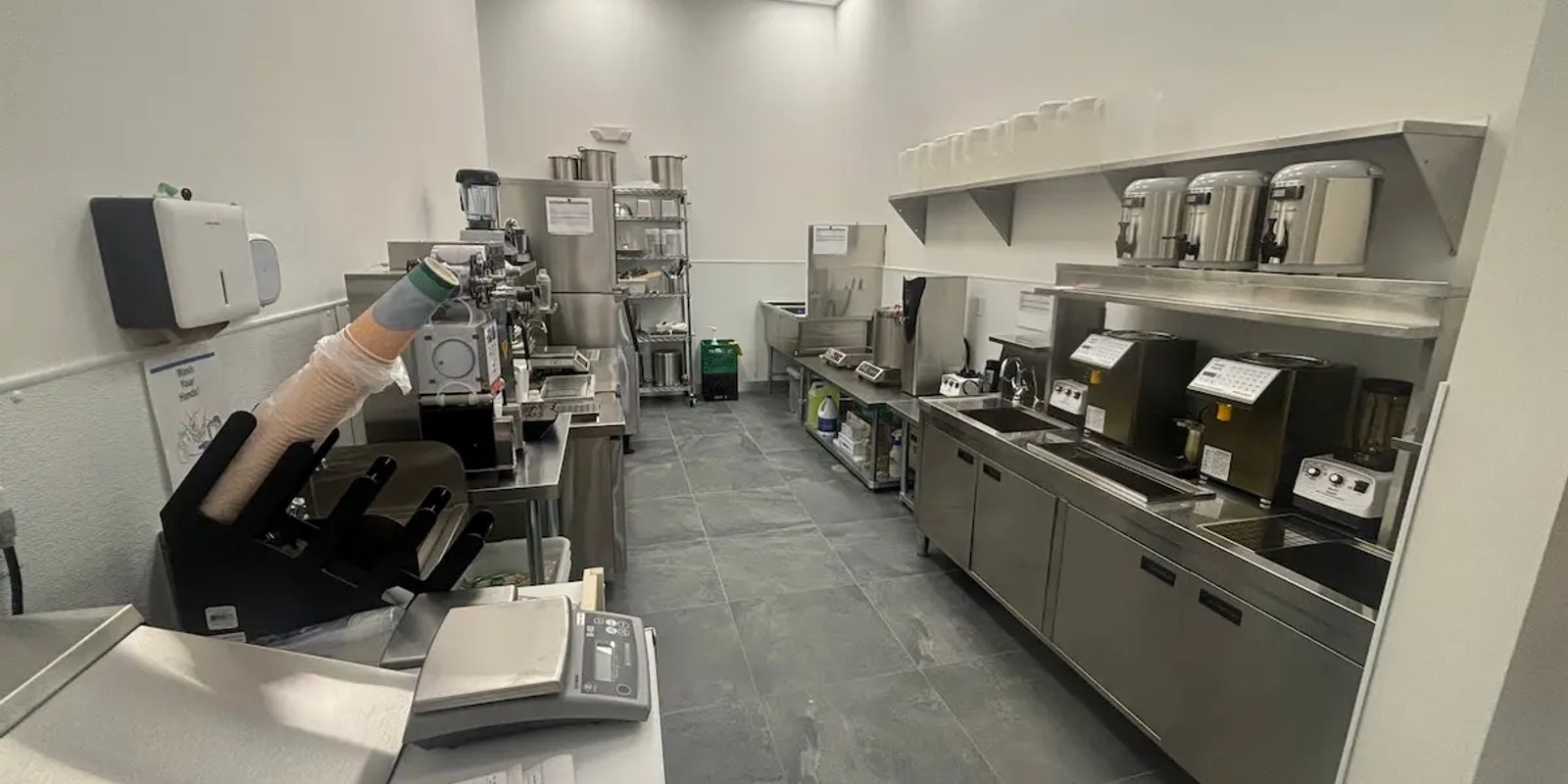 Commercial kitchen equipment and plumbing fixtures in a service area