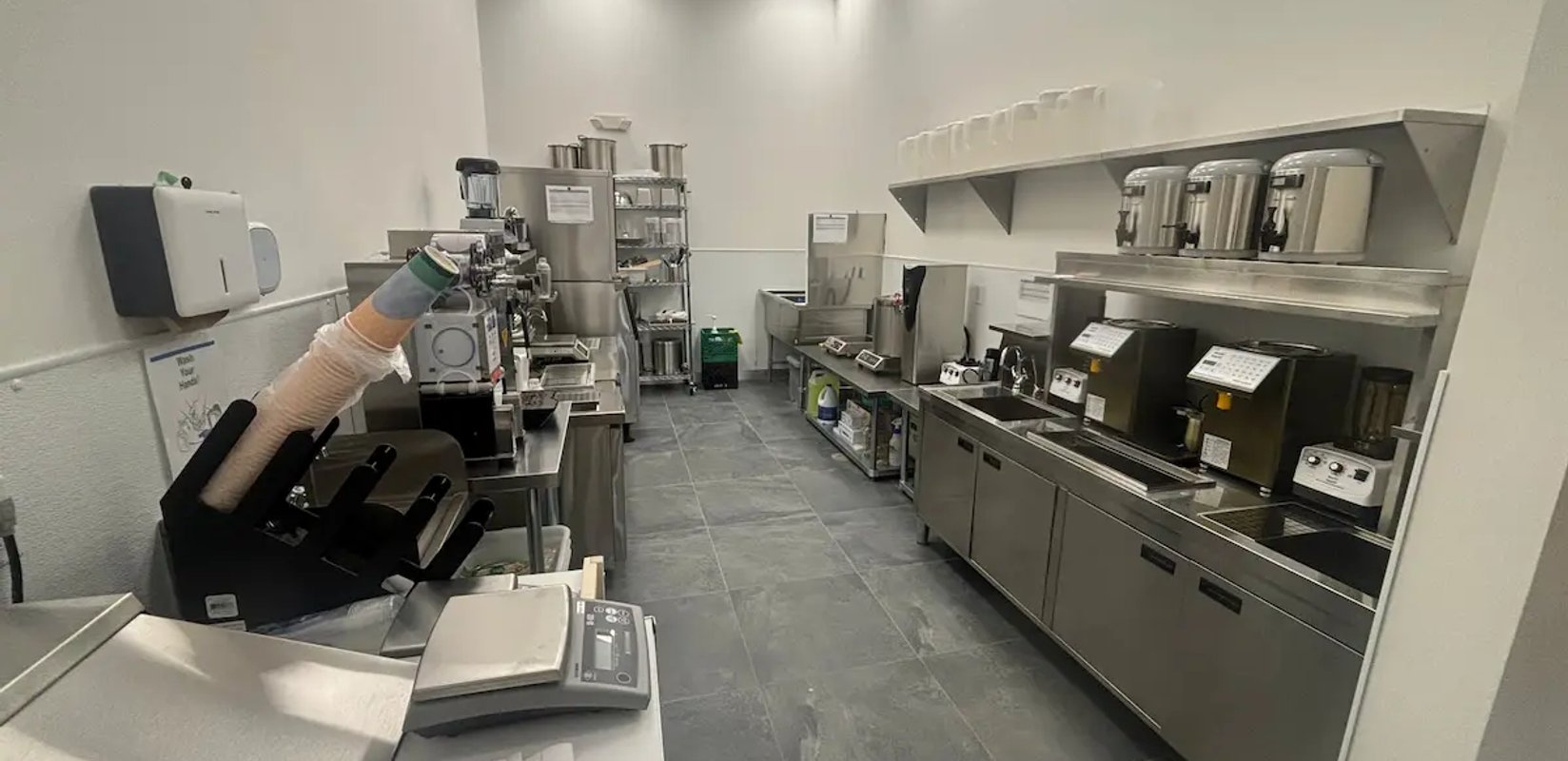 Commercial kitchen equipment and plumbing fixtures in a service area