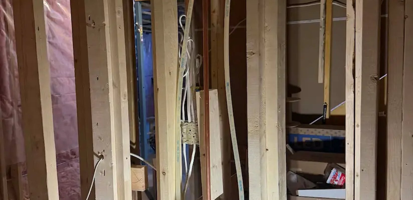 Bathroom framing with rough-in plumbing in progress