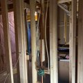 Bathroom framing with rough-in plumbing in progress
