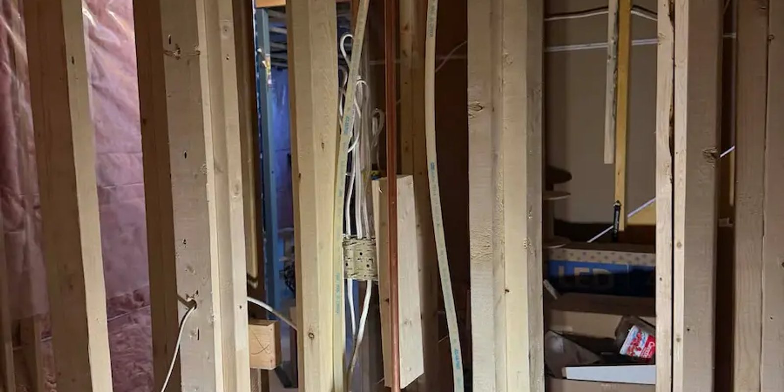 Bathroom framing with rough-in plumbing in progress