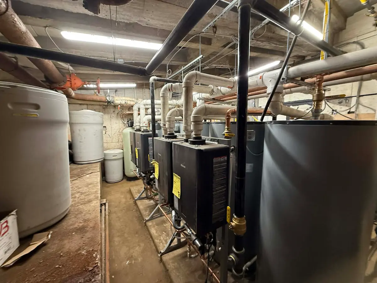Mechanical room aisle with storage tanks and piping