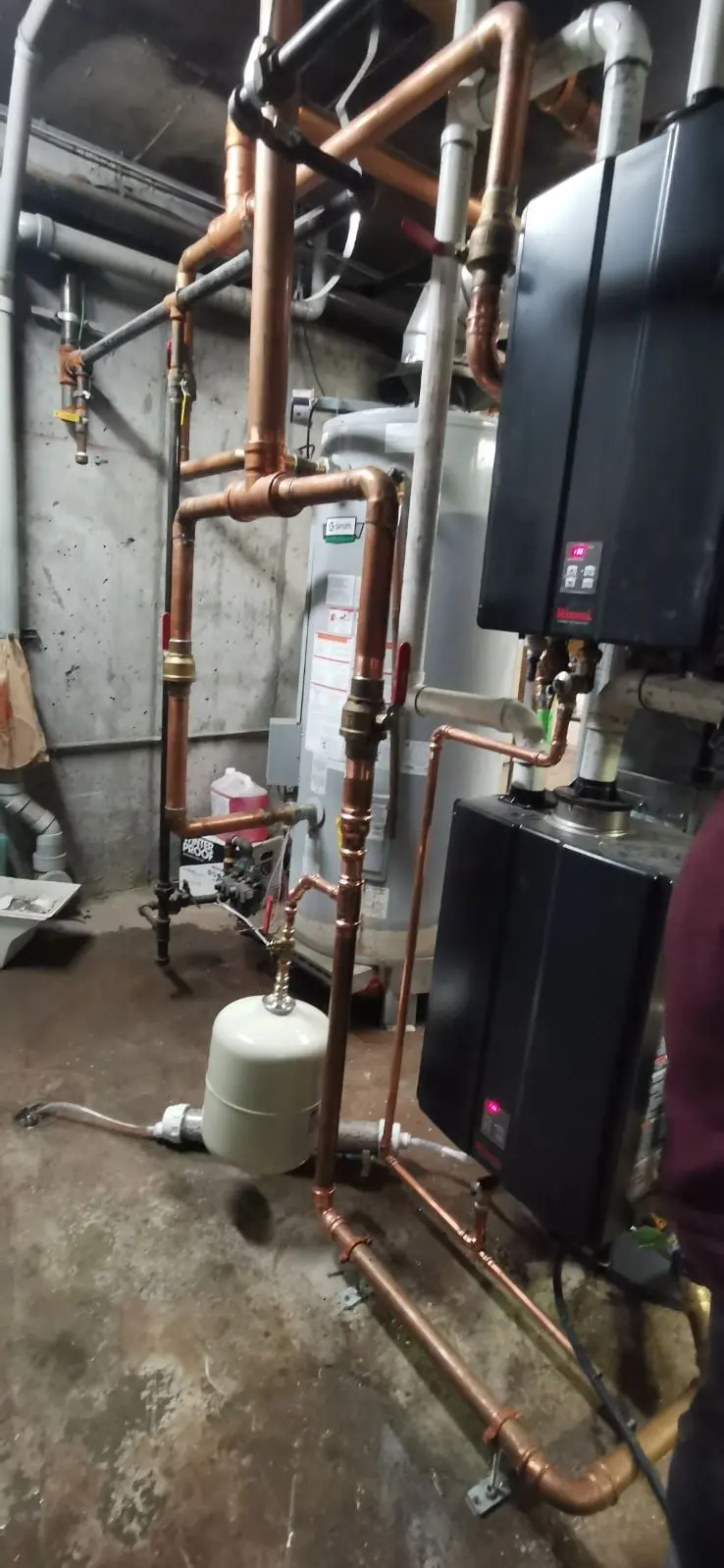 Commercial water tanks connected by insulated piping
