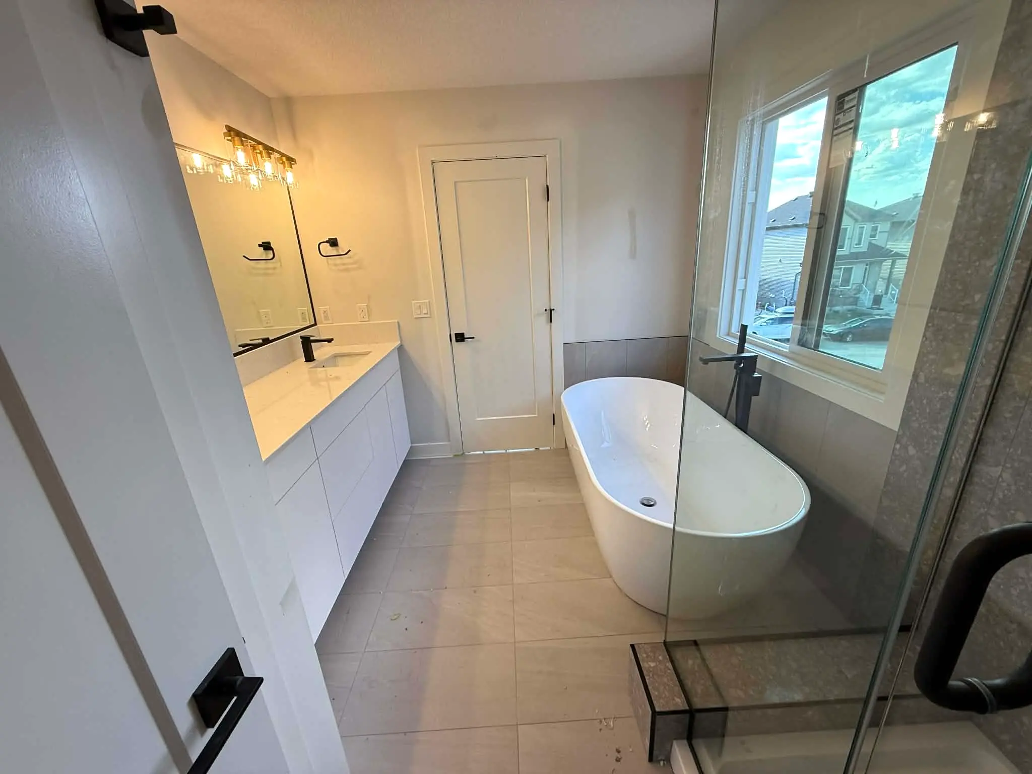 Bright modern bathroom with freestanding tub and double vanity