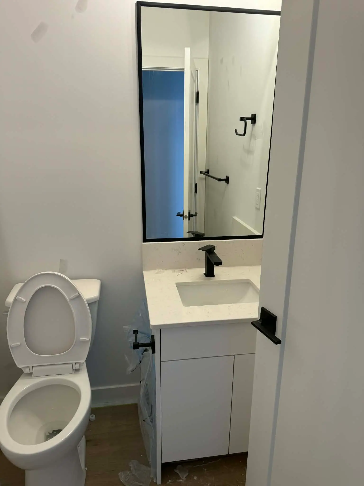 Compact bathroom vanity with toilet and mirror